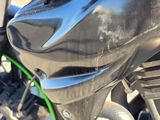 a close up of a motorcycle with a green ring on it