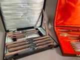 two different types of knives and spoons in a case