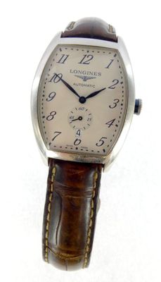 a close up of a wrist watch with a brown leather strap