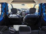 the interior of a small blue car with black seats and a steering wheel
