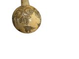 a small vase with a design on it on a white background