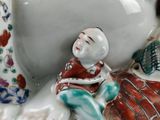 a figurine of a man sitting on a pillow