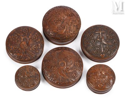 six small wooden boxes with carvings on them sitting on a white surface