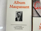 two books on a table with a picture of a man in a suit and tie