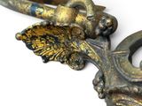 a close up of a metal object with a bird on it