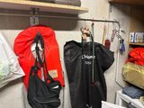 two coats hanging on the wall in a room