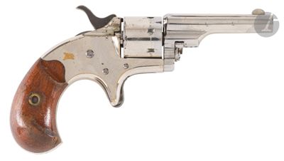 an old revolver with a wooden handle on a white background