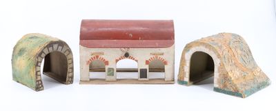 three small toy houses that are sitting on a table