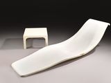 a white chair and a small table in a room