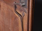 close up of a wooden door with a metal latch on it