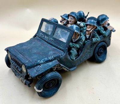 a group of soldiers riding in the back of a toy truck