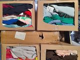 boxes of clothing are stacked on top of each other in a warehouse