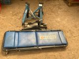 a blue case sitting on the ground next to a pair of jacks