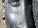 a statue of a man ' s head on a pole