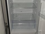 a black refrigerator with its door open in a kitchen