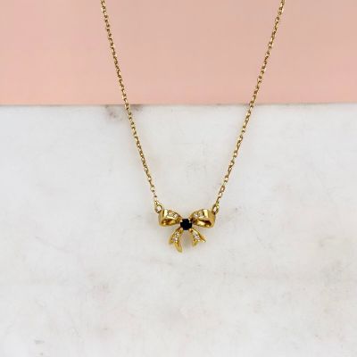 a gold plated necklace with a black stone eye pendant