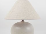 an image of a white lamp with a beige shade on it