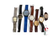 many different types of watches on a white surface