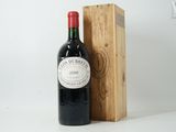 a bottle of wine sitting next to a wooden box