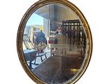 a reflection of a person sitting in a chair in a mirror
