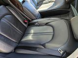 a black car with black leather seats in the back of it