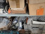 many boxes and tools on a shelf in a room