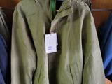three jackets hanging on a hanger with a price tag
