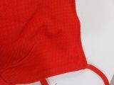a pair of scissors and a red sweater on a table
