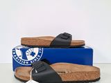 black birkett sandals with cork soles and a blue box