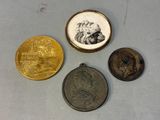 three coins with a picture of a man and a woman on them
