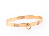 a gold bang bracelet with a diamond clasp