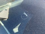 a reflection of a paper airplane in the windshield of a car