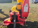 a close up of a red and yellow machine in a field