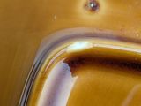 a close up view of a yellow bowl with liquid on it