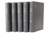four books are lined up in a row on a white surface