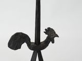 an image of a metal rooster on a stand on a white background