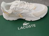 lacoste tennis shoes on a green box with a white and yellow logo