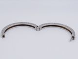 pair of stainless steel bracelets on a white surface