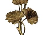 gold plated flower brooch with leaves on a white background