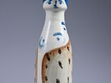 a white vase with a blue and brown design on it