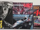 three books of nascar racing on a shelf in a room