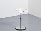 a white stool sitting in a corner of a room