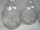 three glass vases sitting on a white surface