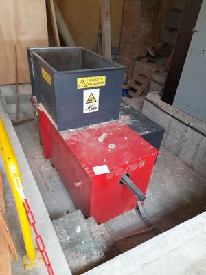 a red box with a yellow sticker on it in the middle of a construction site