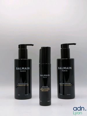 three bottles of balmain hair care on a white background