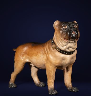 figurine of a dog with a collar on a dark blue background