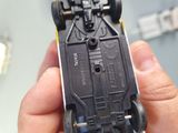 a person holding a toy car in their hand