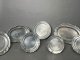 six silverplated trays on a table with a red box