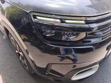 a close up of the front of a car with its lights on