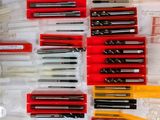 many different pens and pencils laid out on a table